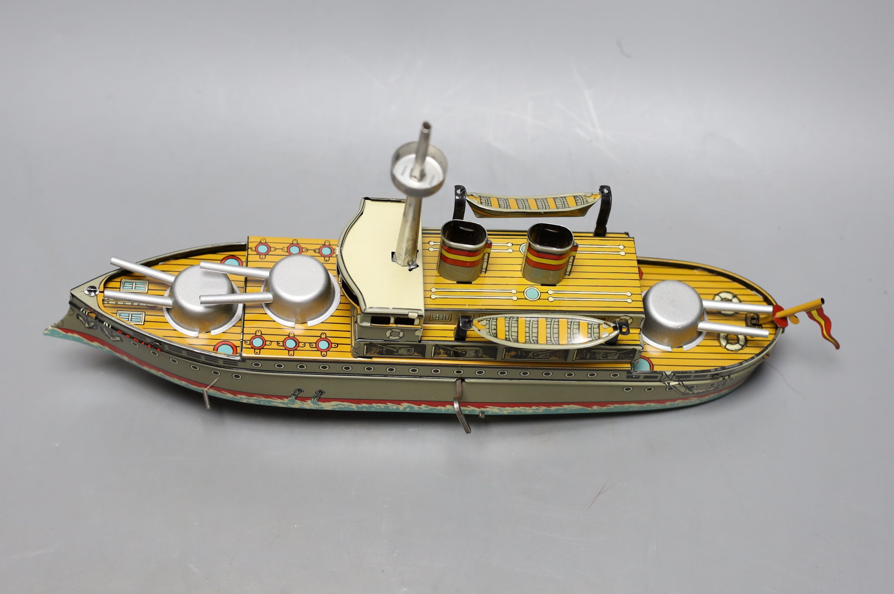 Three IBA tinplate boxed toys, two boats and a train, largest boat 42 cms wide.